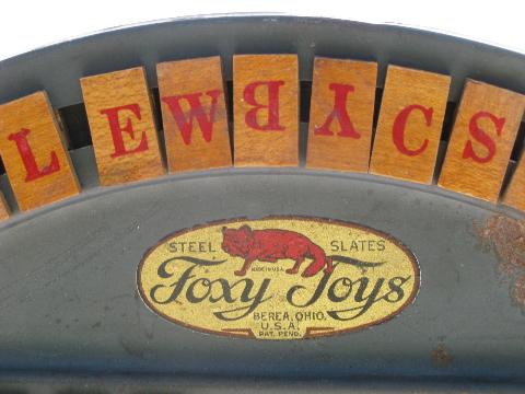 antique Foxy tin spelling wheel toy, wood letter tiles, vintage game board