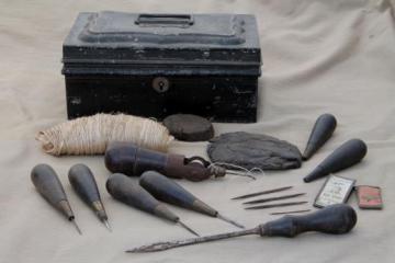 antique leatherworking kit, shoemaker's cobbler leather tools in old tin tool box