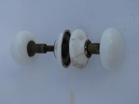 antique white ironstone porcelain and brass door knobs with matching china cover plates