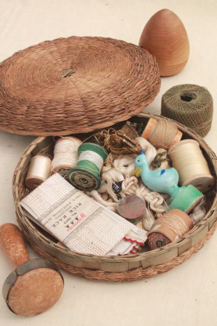 antique wicker sewing basket full of vintage notions, thread spools, sock darners etc.