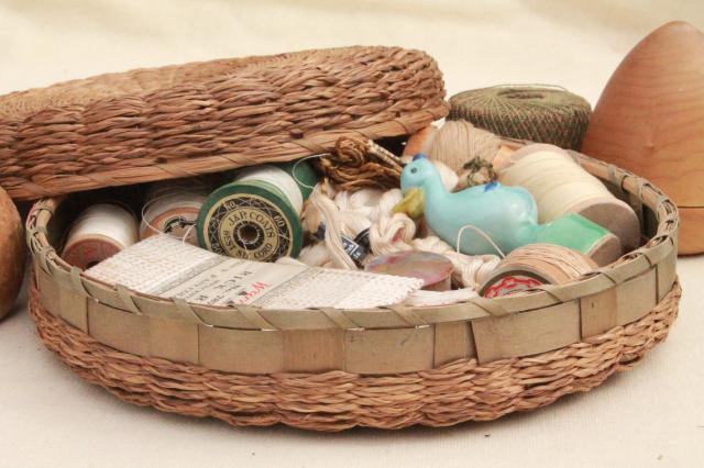 antique wicker sewing basket full of vintage notions, thread spools, sock darners etc.