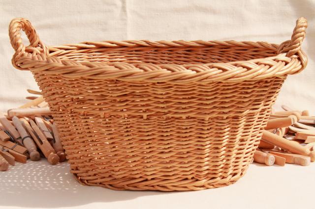 child's size vintage wicker laundry basket full of old wood clothespins