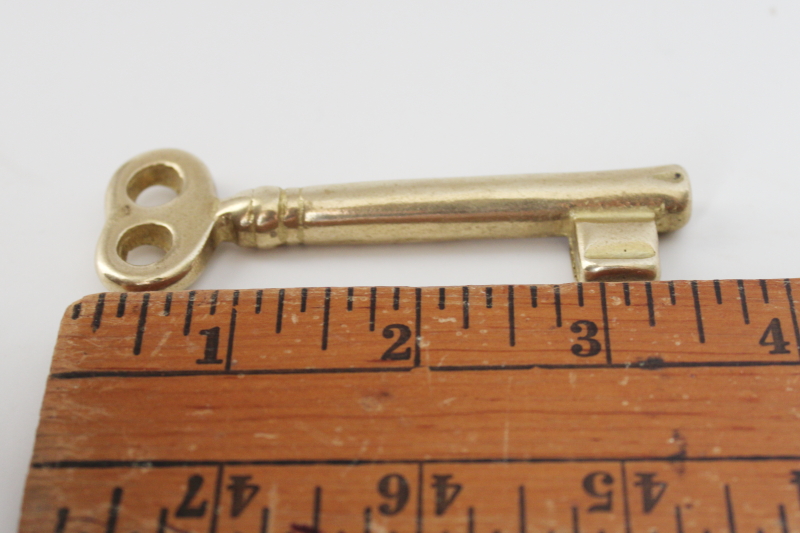 heavy solid brass key paperweight, large skeleton key shape polished brass