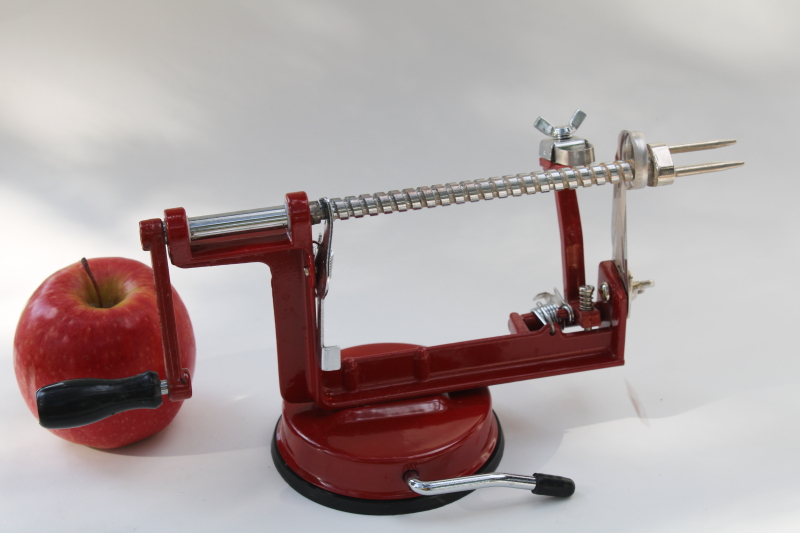 old fashioned red metal hand crank apple peeler, vintage style kitchen tool