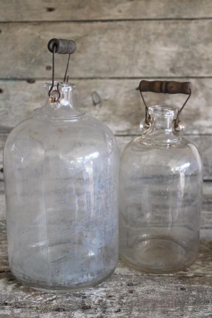 primitive old glass half & gallon bottles, moonshine jug jars w/ wire bail wood handles