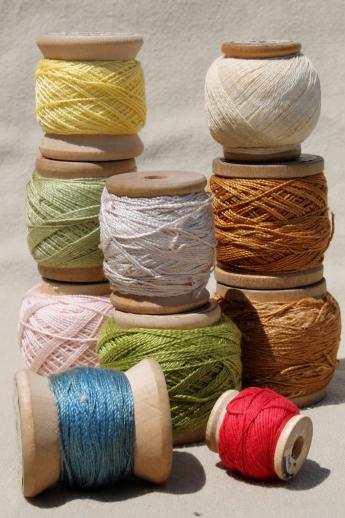 primitive wood spools of colored thread, vintage pearl cotton embroidery floss