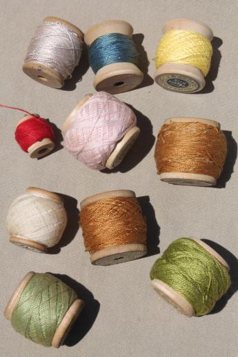 primitive wood spools of colored thread, vintage pearl cotton embroidery floss