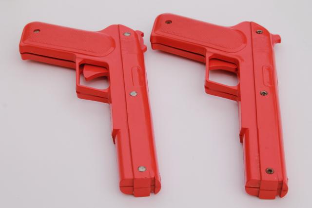 sci-fi style vintage red plastic rubber band shooters, toy guns pair of pistols
