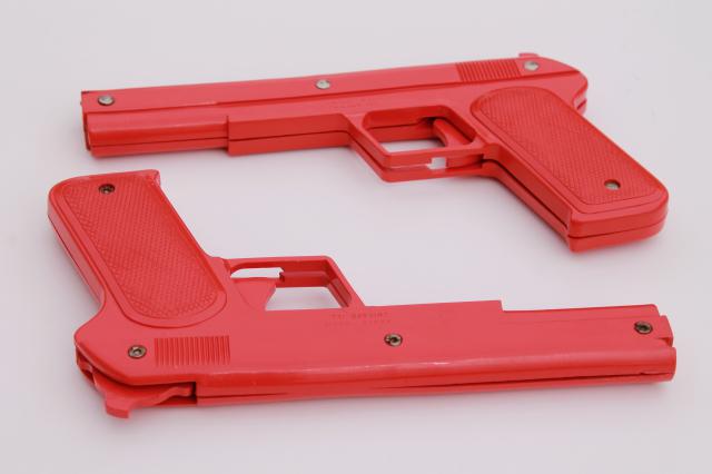 sci-fi style vintage red plastic rubber band shooters, toy guns pair of pistols