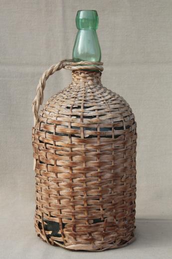 shabby vintage basket covered bottles, lot of old green glass wine bottles in baskets
