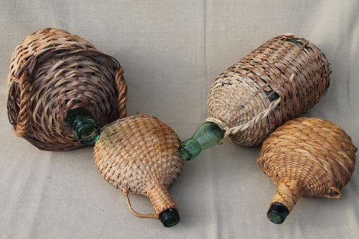 shabby vintage basket covered bottles, lot of old green glass wine bottles in baskets