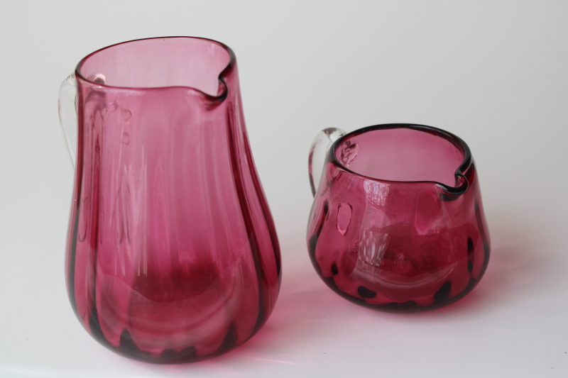 vintage Pilgrim hand blown cranberry glass, two small pitchers w/ clear glass handles