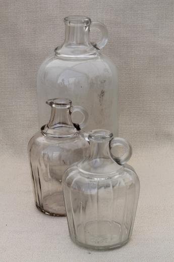 vintage glass bottles, lot of old glass syrup jugs large & small
