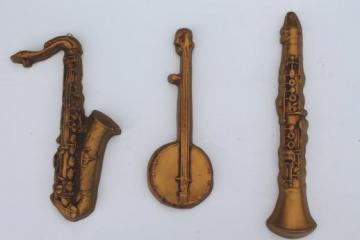 vintage jazz band musical instrument wall plaques, chalkware sax, clarinet, banjo