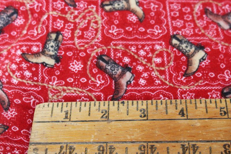 western boots on red bandana print cotton flannel fabric, cowboy / cowgirl dude ranch