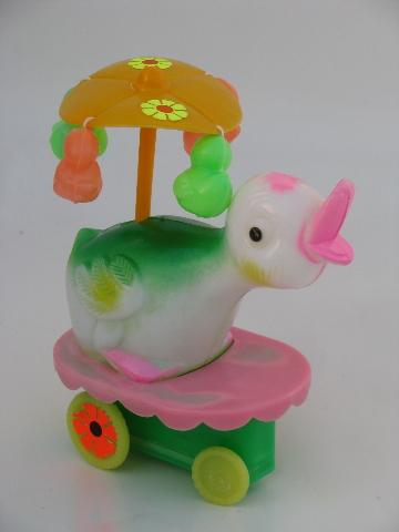 wind-up vintage Easter duck toy, merry-go-round parasol flower cart