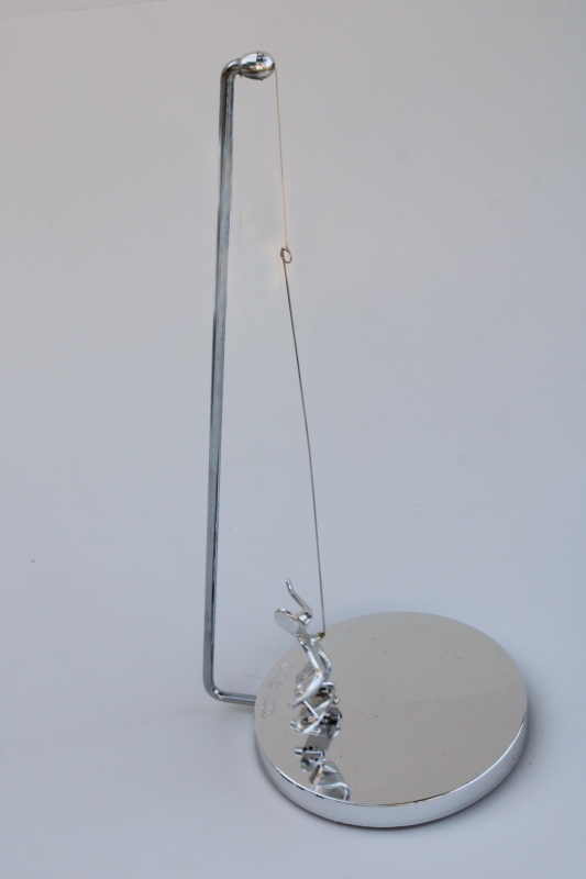70s vintage kinetic sculpture, magnet pendulum perpetual motion skateboarder in mod chrome