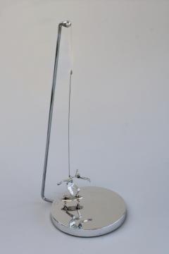 70s vintage kinetic sculpture, magnet pendulum perpetual motion skateboarder in mod chrome