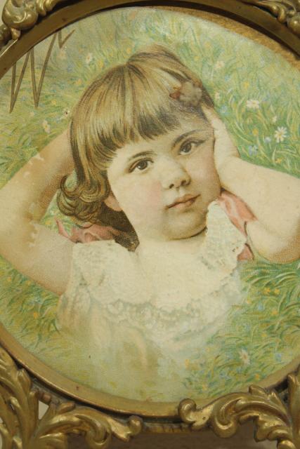 antique gilt picture frame w/ litho print young girl, small round ornate  embossed brass frame