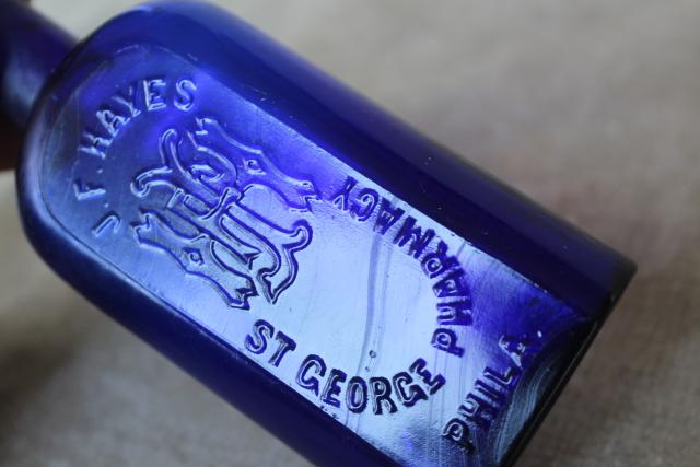 antique vintage embossed glass medicine bottle St George's Pharmacy cobalt blue glass