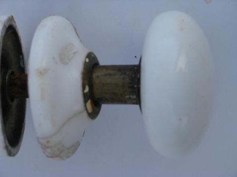 antique white ironstone porcelain and brass door knobs with matching china cover plates