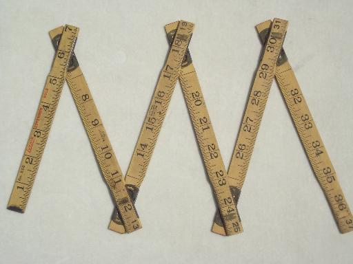 antique wood measures, brass bound folding scales, old advertising tool rulers