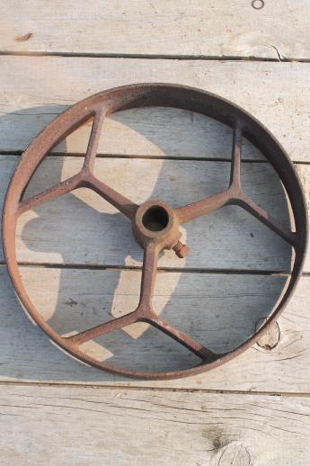 big old iron fly wheel from steampunk vintage industrial machinery or farm equipment