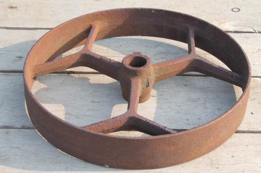 big old iron fly wheel from steampunk vintage industrial machinery or farm equipment