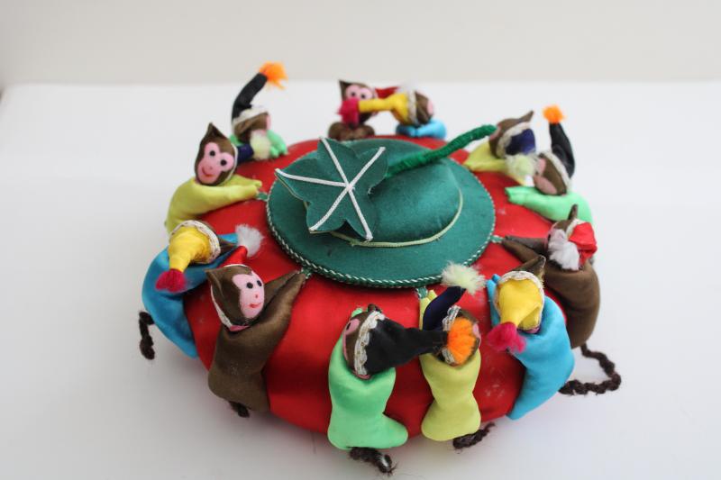 big old round Chinese satin pincushion w/ ring of worry dolls tiny monkeys in hats