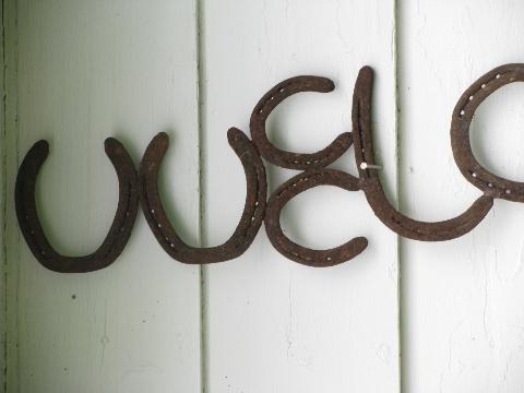 big rustic western ranch Welcome sign, old wrought iron horseshoe letters