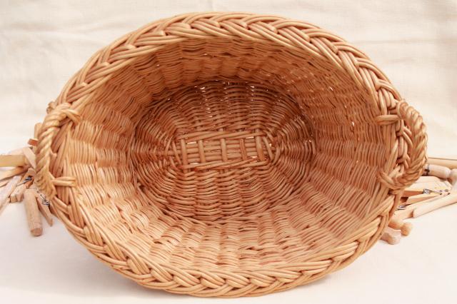 child's size vintage wicker laundry basket full of old wood clothespins
