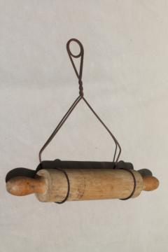 country primitive antique wood rolling pin in rustic old wire wall holder rack