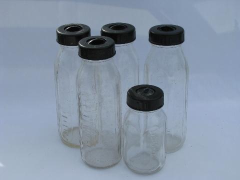 large lot assorted old glass baby bottles, vintage bakelite lids
