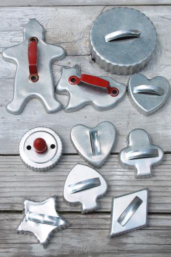lot of vintage metal cookie cutters, old aluminum cookie cutters w/ red handles etc.