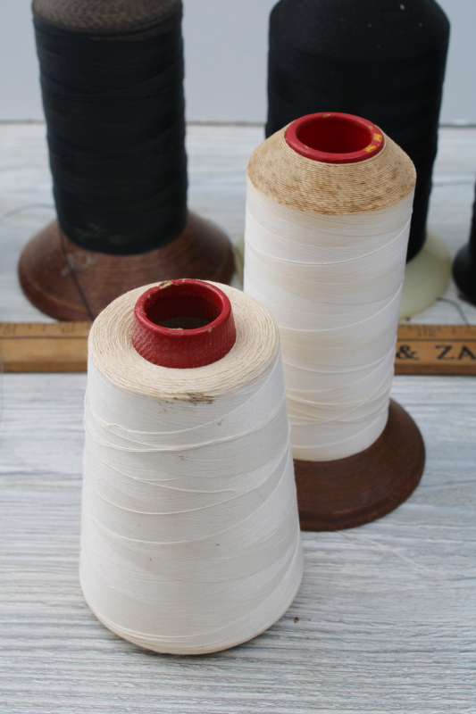 lot old industrial spools of thread, grubby white, black, neutral colors for rustic vintage display