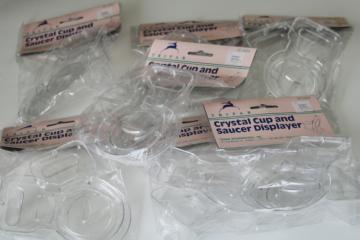new old stock 90s vintage cup saucer holders, clear plastic display stands sealed pkgs