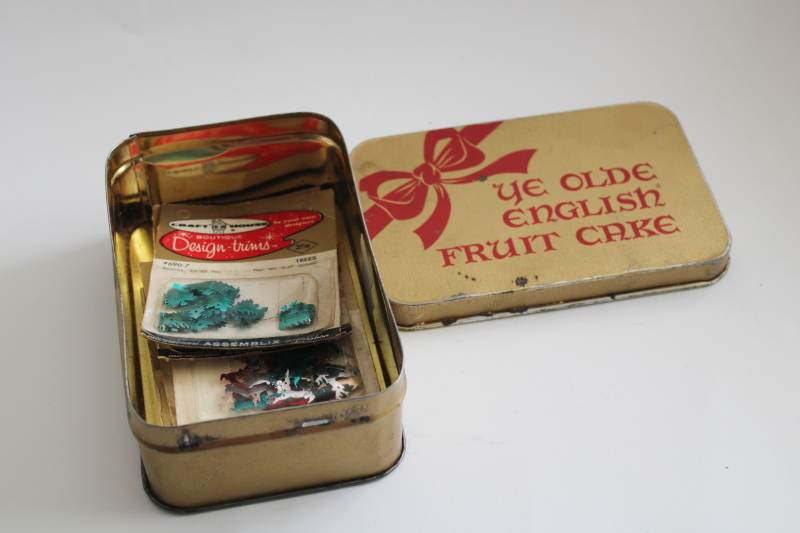 old fruitcake tin w/ packages of sequins for Christmas decorations or beaded ornaments