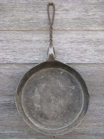 primitive old campfire or wood stove frying pan, skillet w/ wirework handle