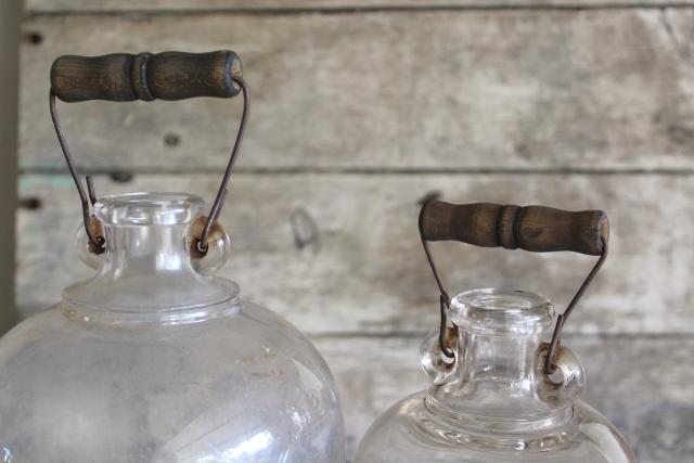 primitive old glass half & gallon bottles, moonshine jug jars w/ wire bail wood handles