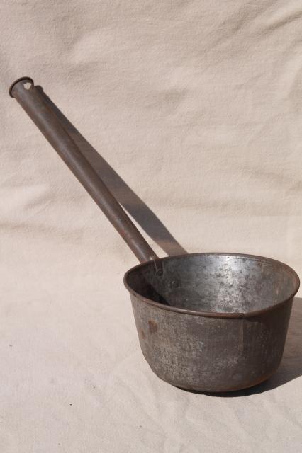 primitive old tin metal dipper, big soup ladle or water pail drinking cup