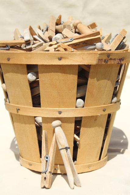 primitive wood fruit basket full of old wood clothespins