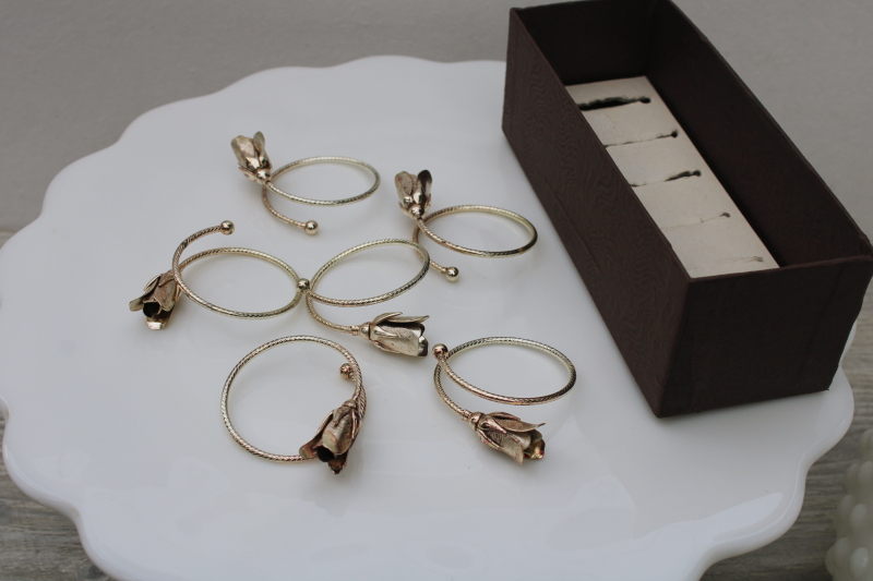 silvery metal bangle style napkin rings, flower buds or roses on narrow bracelet