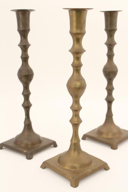 trio of vintage tarnished brass candle sticks, tall altar candlesticks