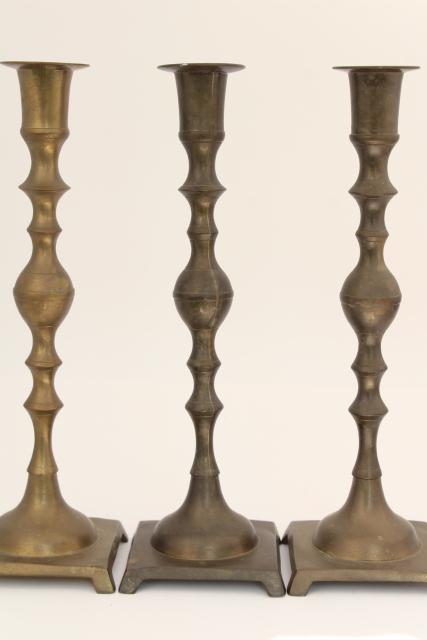 trio of vintage tarnished brass candle sticks, tall altar candlesticks