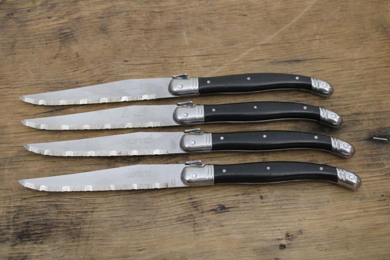vintage Laguiole France steak knives set of four, black plastic handles w/ bee