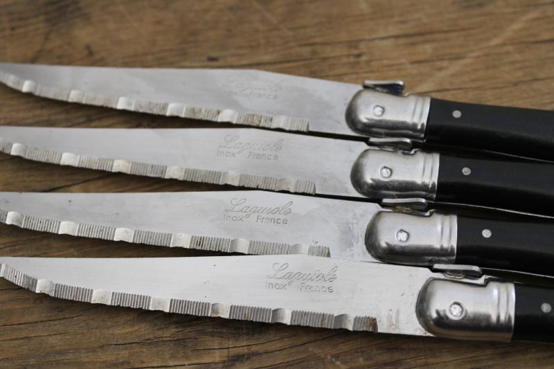 vintage Laguiole France steak knives set of four, black plastic handles