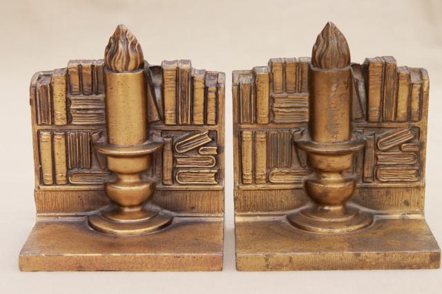 vintage cast metal bookends w/ antique brass finish, book & candle stick stacks of books