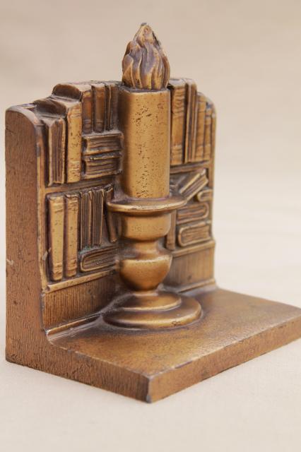 vintage cast metal bookends w/ antique brass finish, book & candle stick stacks of books