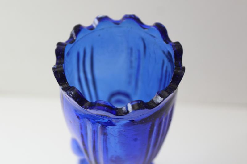 vintage cobalt blue glass vase, lady's hand holding trumpet shaped flower