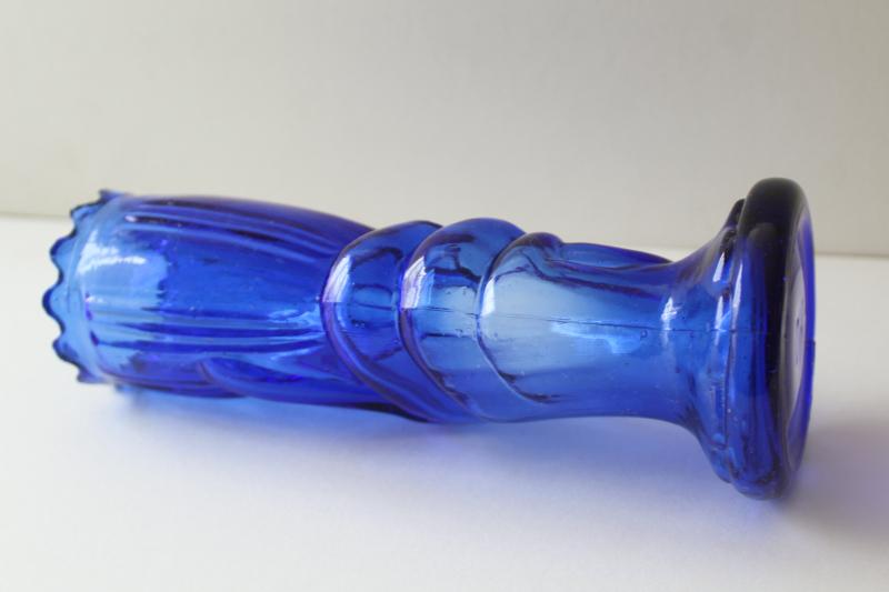 vintage cobalt blue glass vase, lady's hand holding trumpet shaped flower
